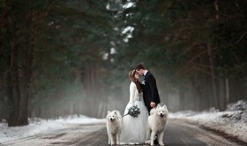 Winter bride and groom outside on a snow-covered road. Winter bride and groom outside on a snow-covered road.