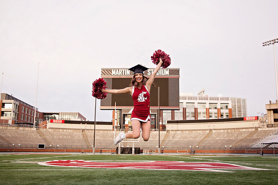 Photo of a student next to an eisle upon our Coral Whimsical Frame Graduation Invitation.